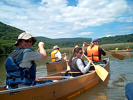 Man paddling canoe at Iona Island during trip with NYSDEC staff.