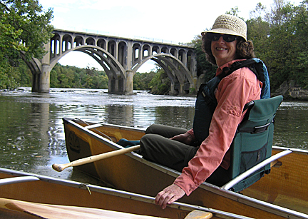 Woman in canoe near bridge at Stockport Flats.